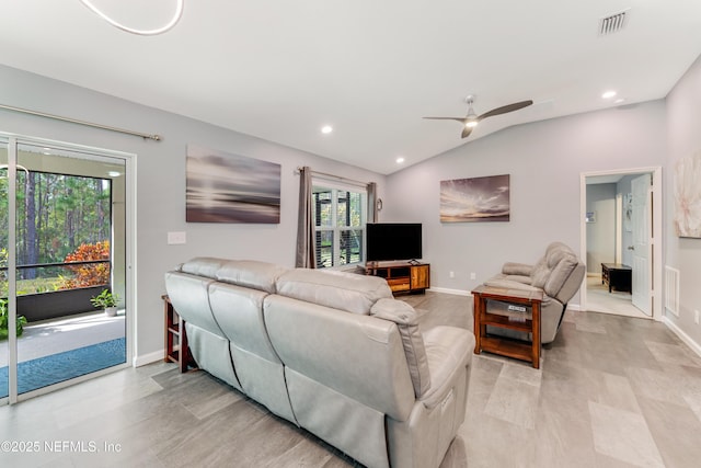 living room with ceiling fan and lofted ceiling