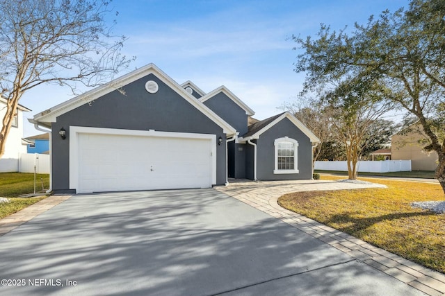 view of front of house with a garage and a front lawn