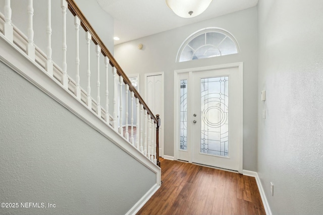 entrance foyer featuring a high ceiling and dark hardwood / wood-style flooring