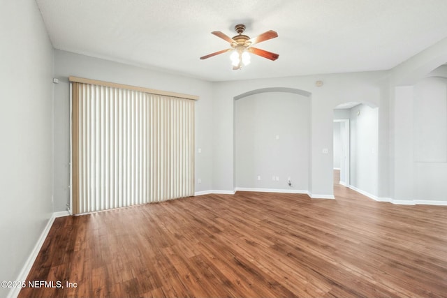 empty room featuring hardwood / wood-style flooring and ceiling fan