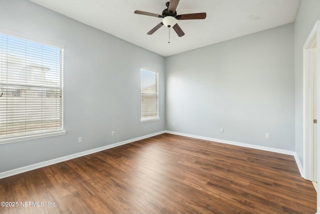 empty room with ceiling fan and dark hardwood / wood-style flooring