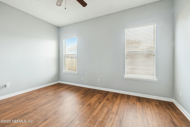 unfurnished room featuring ceiling fan and dark hardwood / wood-style flooring