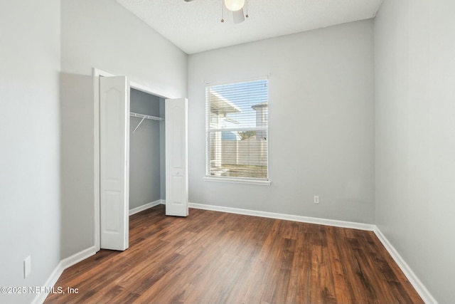 unfurnished bedroom featuring a closet, ceiling fan, and dark hardwood / wood-style flooring