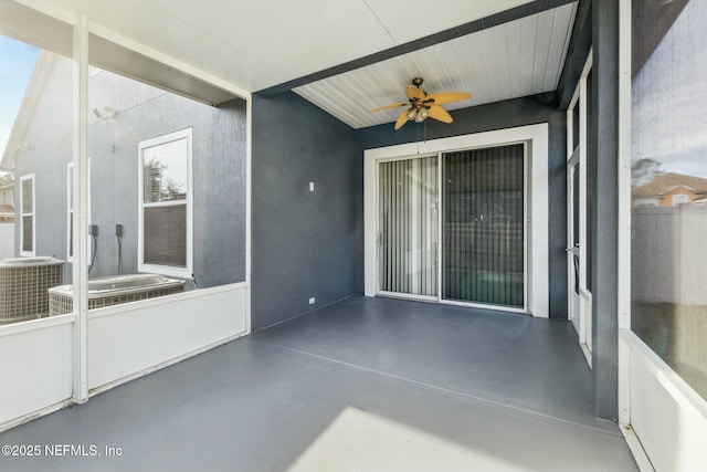 unfurnished sunroom with ceiling fan