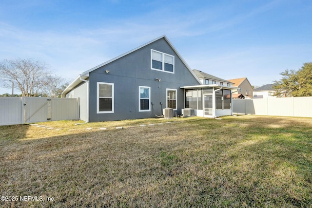 back of house with a lawn, central AC, and a sunroom