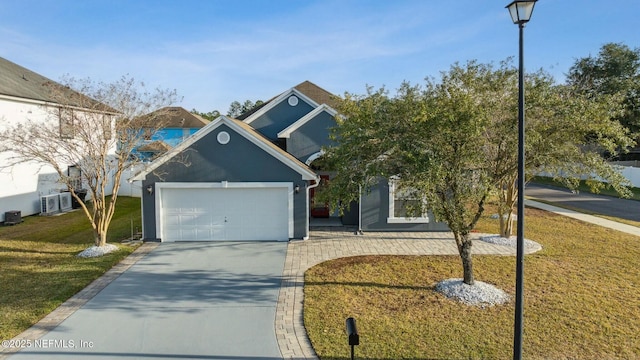 view of front property with a garage, central air condition unit, and a front lawn