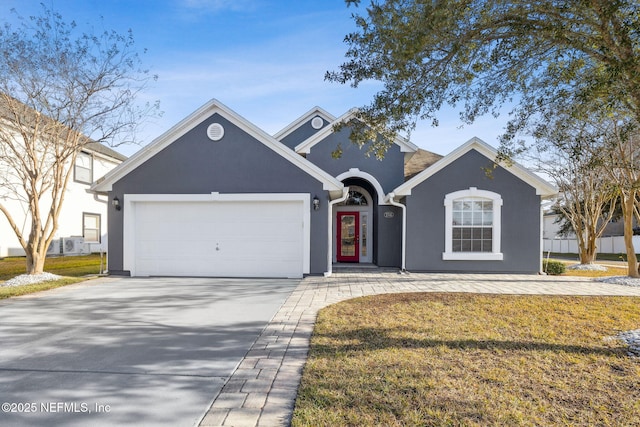 front facade featuring a garage and a front yard