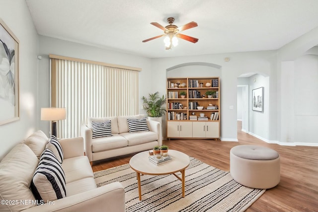 living room with ceiling fan and hardwood / wood-style floors