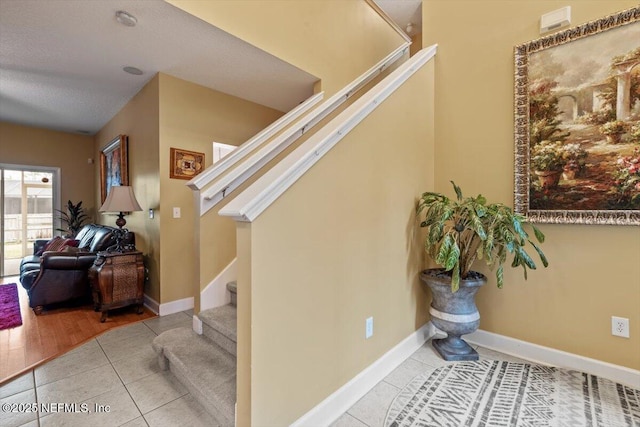 stairs featuring tile patterned floors