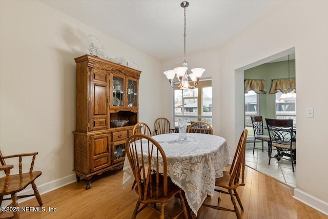 dining room featuring a chandelier and light wood-type flooring