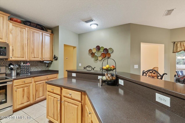 kitchen featuring a textured ceiling, light brown cabinets, light tile patterned floors, stainless steel appliances, and decorative backsplash