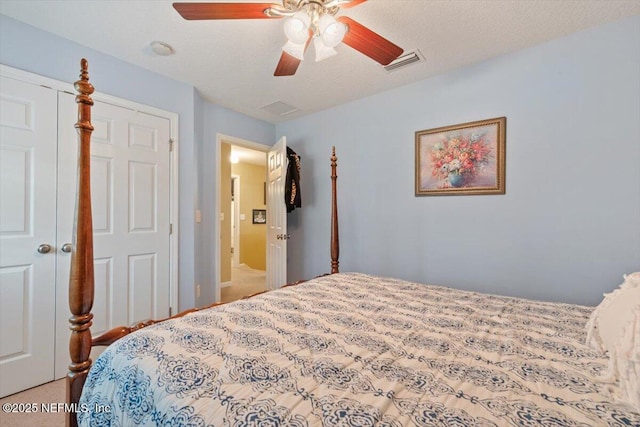 carpeted bedroom featuring a textured ceiling, a closet, and ceiling fan