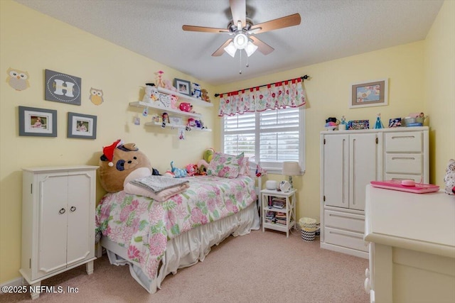 carpeted bedroom featuring a textured ceiling and ceiling fan