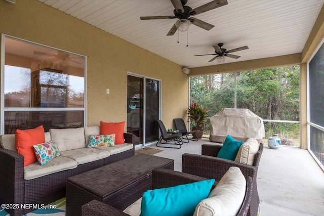 sunroom featuring ceiling fan