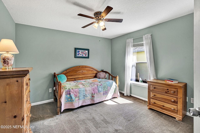 carpeted bedroom with a ceiling fan, a textured ceiling, and baseboards