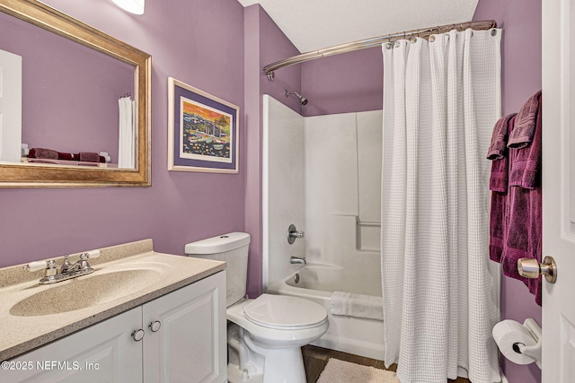 bathroom featuring toilet, shower / bath combo with shower curtain, and vanity