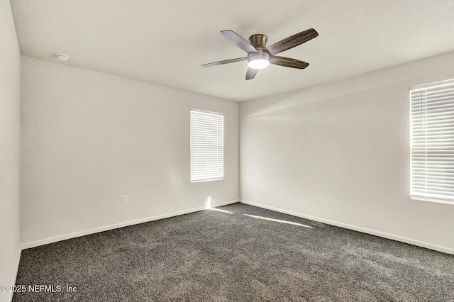 carpeted spare room with ceiling fan