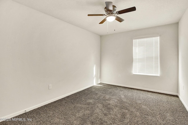 unfurnished room with ceiling fan and carpet flooring