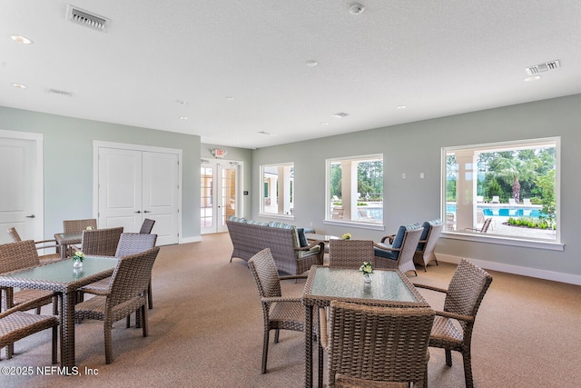 dining room featuring carpet and french doors