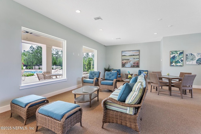 living room featuring a wealth of natural light and carpet