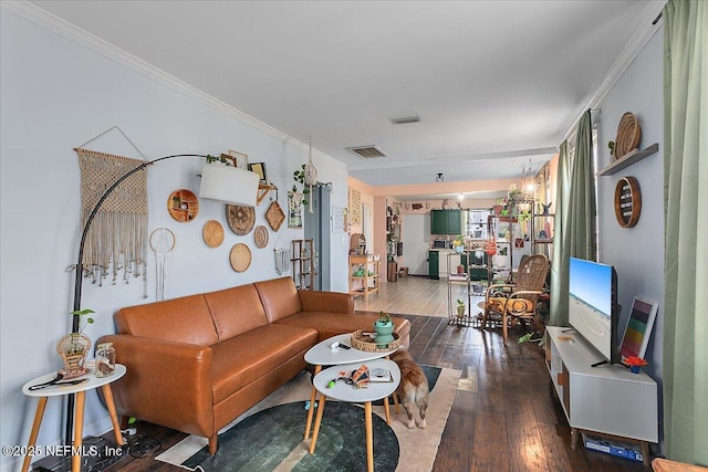 living room featuring crown molding, wood-type flooring, and a notable chandelier