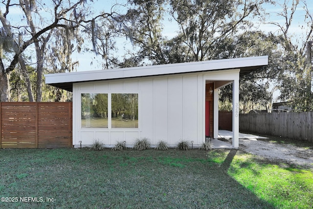 view of outbuilding with a lawn