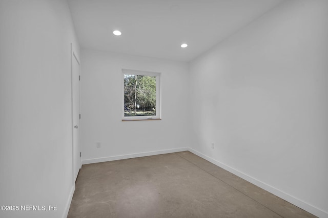 spare room with concrete flooring