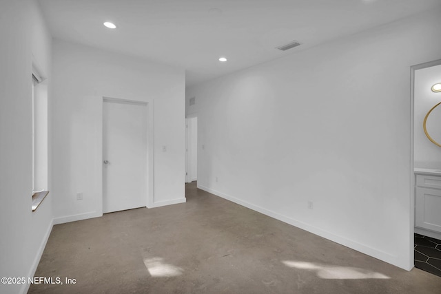 unfurnished room featuring concrete floors