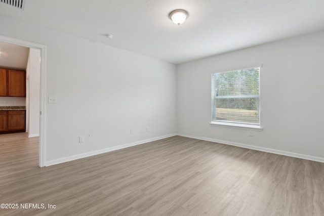 spare room featuring light wood-type flooring