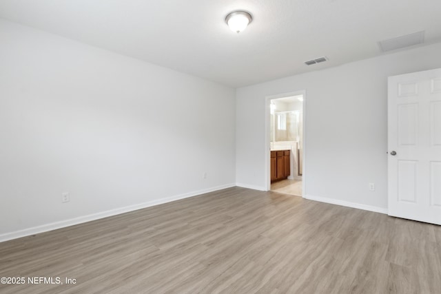 spare room featuring light wood-type flooring