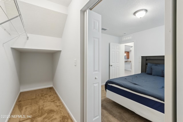 carpeted bedroom featuring a textured ceiling