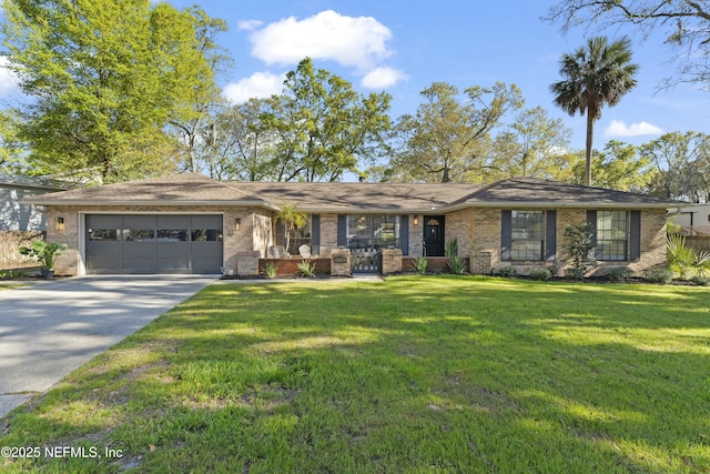 ranch-style house featuring a garage, a front yard, brick siding, and driveway