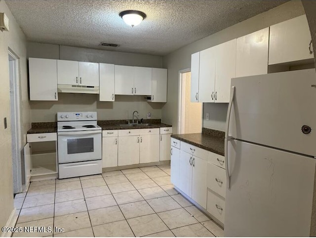 kitchen featuring a textured ceiling, white cabinetry, sink, and white appliances