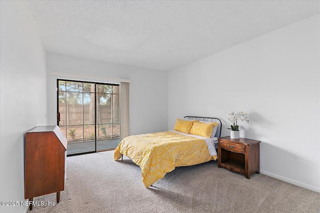 bedroom featuring carpet floors, a textured ceiling, and access to outside