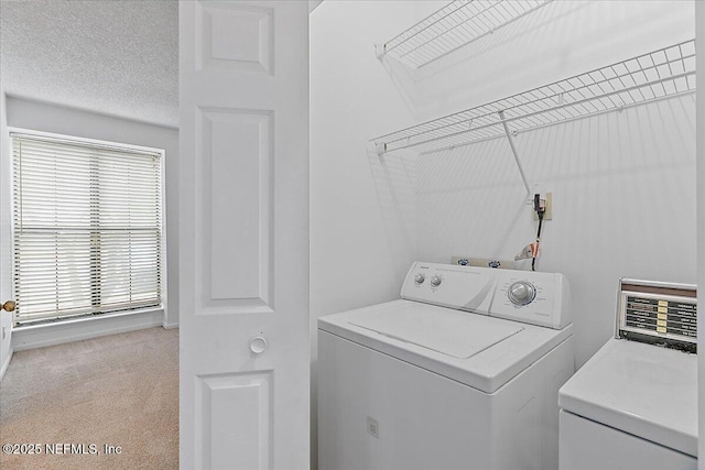 laundry room with washing machine and clothes dryer, plenty of natural light, and carpet floors