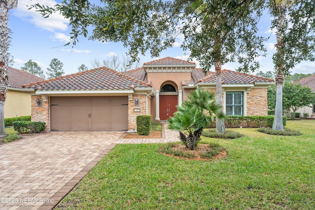 mediterranean / spanish home with a garage and a front yard