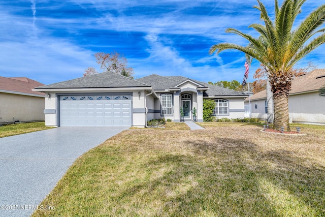 single story home featuring a garage and a front yard