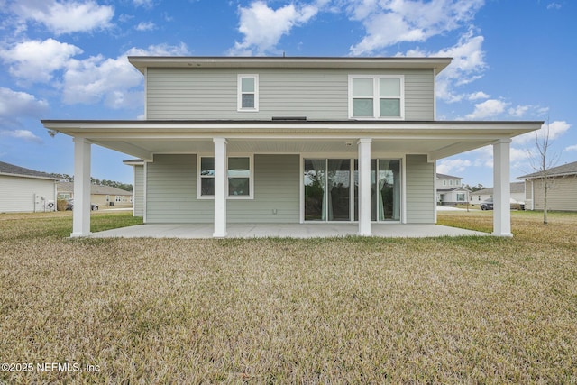 rear view of house featuring a patio and a lawn