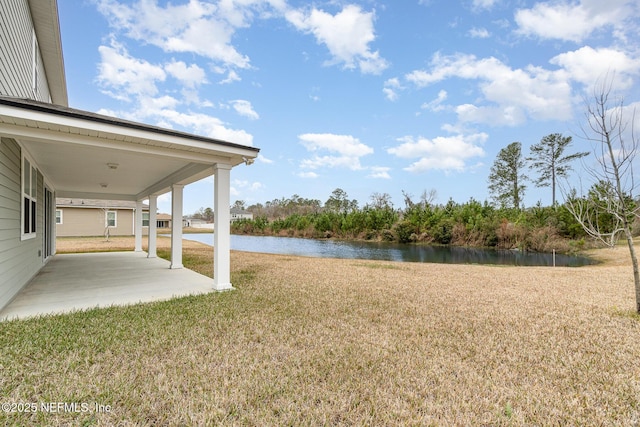 view of yard with a water view and a patio area