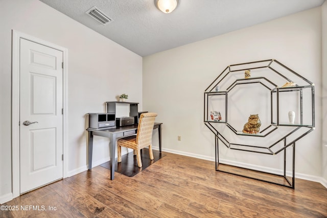 office area featuring hardwood / wood-style flooring and a textured ceiling