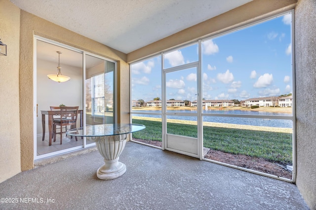 unfurnished sunroom with a water view