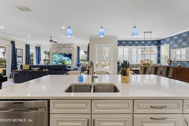 kitchen featuring light stone counters, crown molding, dishwasher, and sink