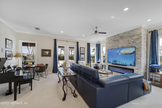 living room with ornamental molding, light colored carpet, ceiling fan, and french doors