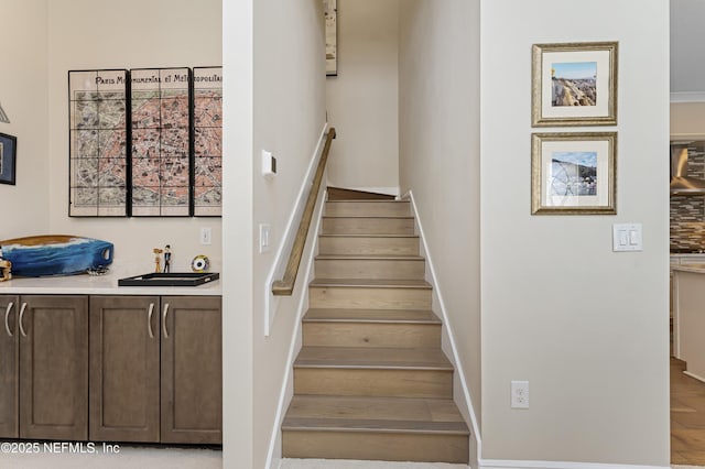 stairway featuring sink