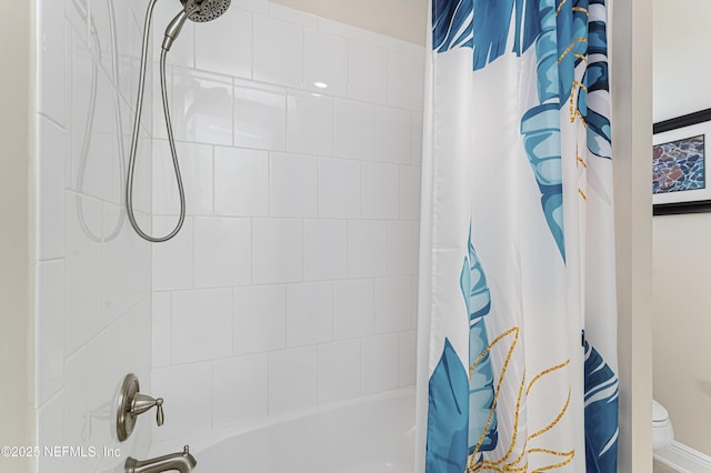 bathroom with shower / tub combo and toilet