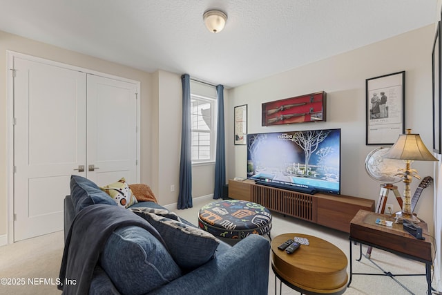 living room featuring light carpet and a textured ceiling