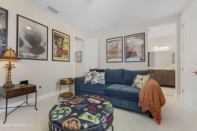 living room with light carpet and sink