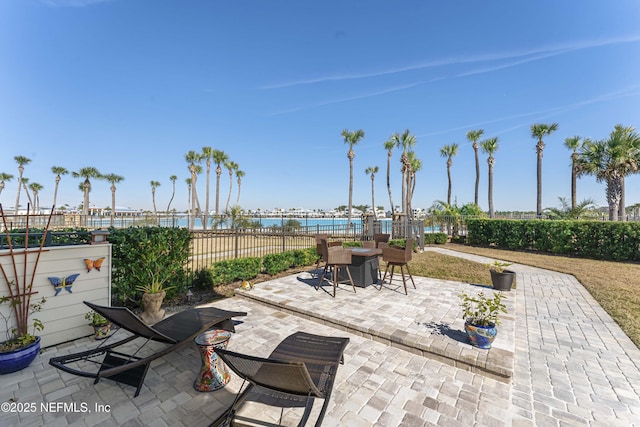 view of patio with a water view