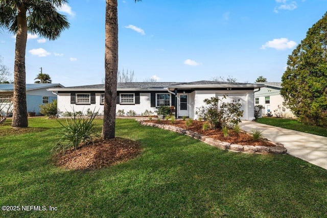 ranch-style house with a garage and a front lawn