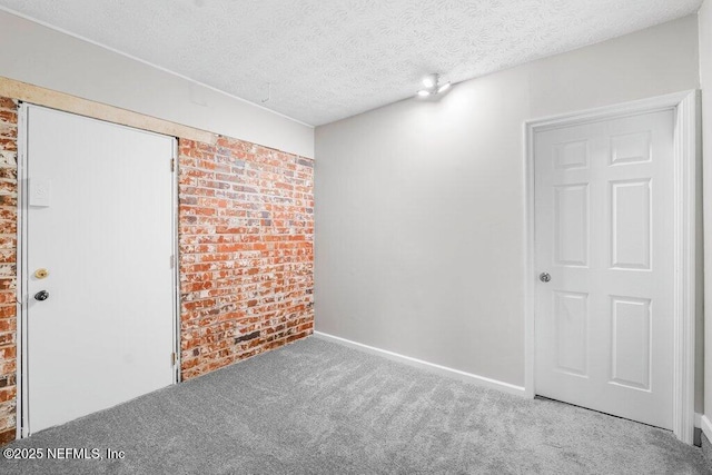 carpeted spare room with a textured ceiling